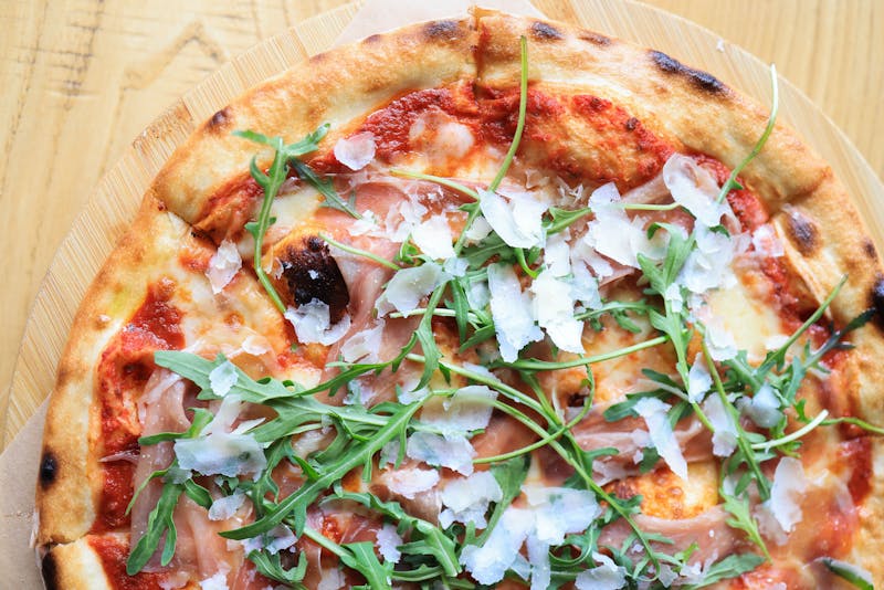Prosciutto and arugula specialty pizza